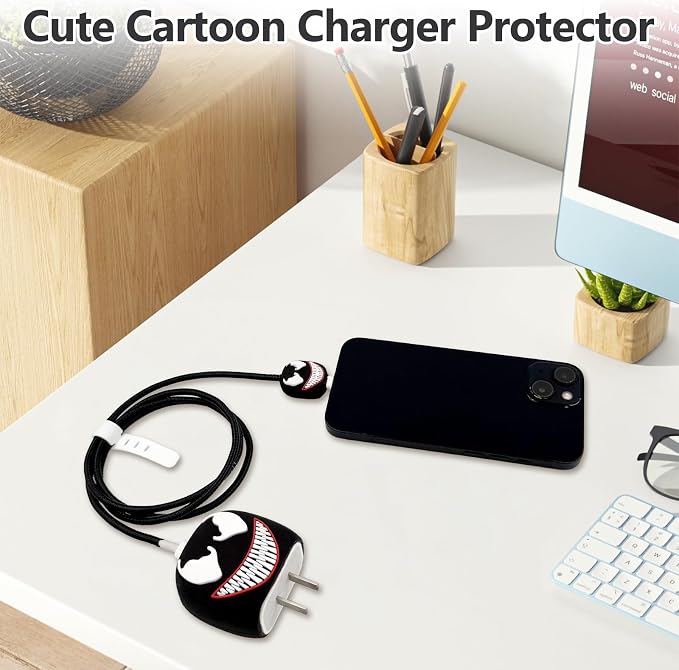 Venom charger adapter cover, mini cable protector and black spiral cable winder flat lay on grey surface