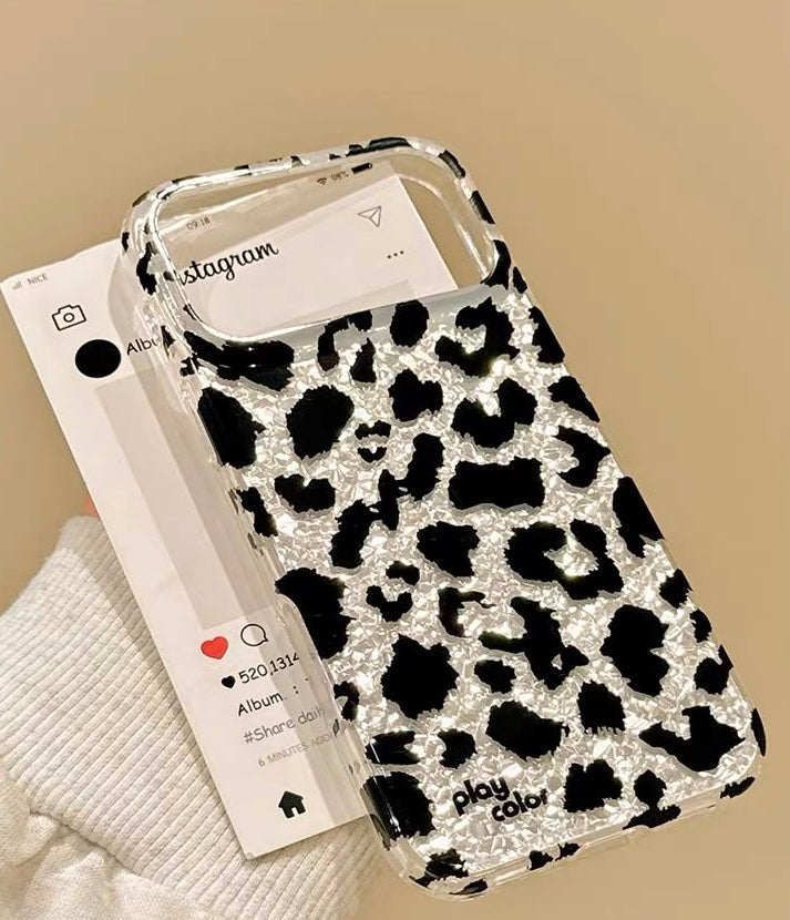 Snow leopard iPhone case on white plate flat lay