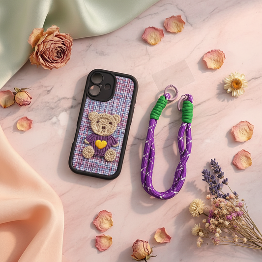 Purple Teddy Bear iPhone Case styled flat lay with purple wrist strap