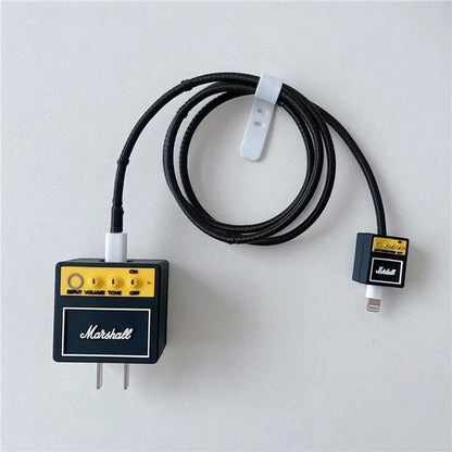 Rock amp charger adapter cover and mini amp cable bite with black coil winder - product flat lay on white background