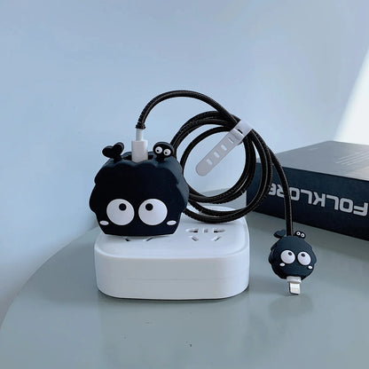 Black fluffy spirit charger cover and mini spirit cable protector with black spiral cable wrap flat lay on white surface