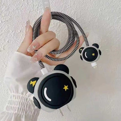 Cute panda face charger cover and cable protector held up against white wall