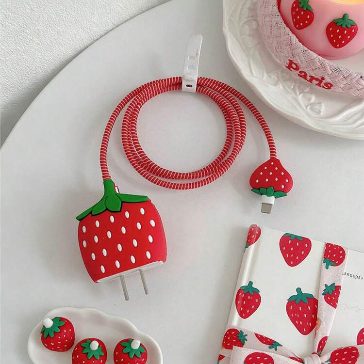 Strawberry iPhone Charger Adapter Cover and Cable Protector Set styled on table – iPouch