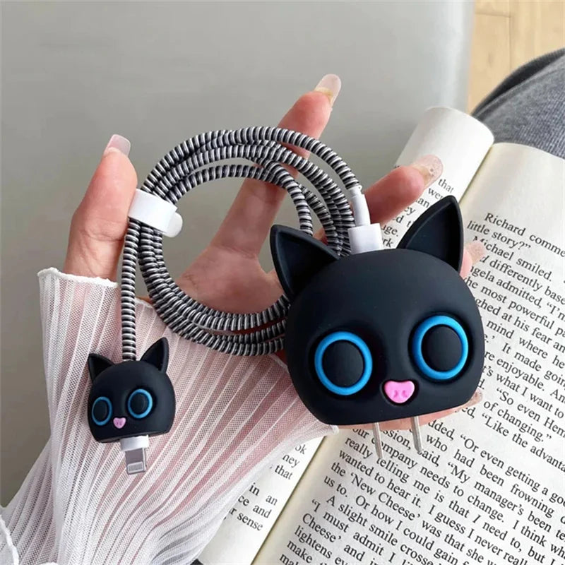 Black cat charger adapter cover with black coil winder held in hand - lifestyle shot