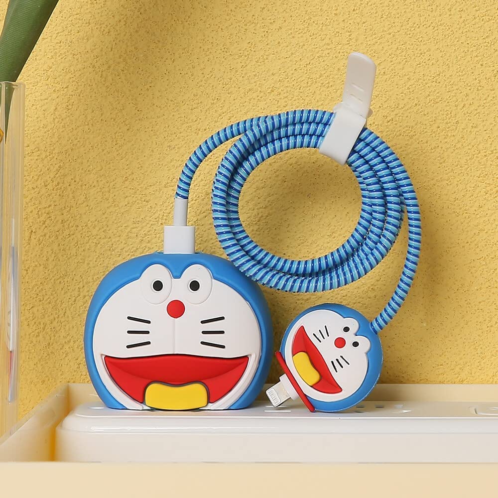 Blue kawaii cat face charger cover on shelf with cable winder
