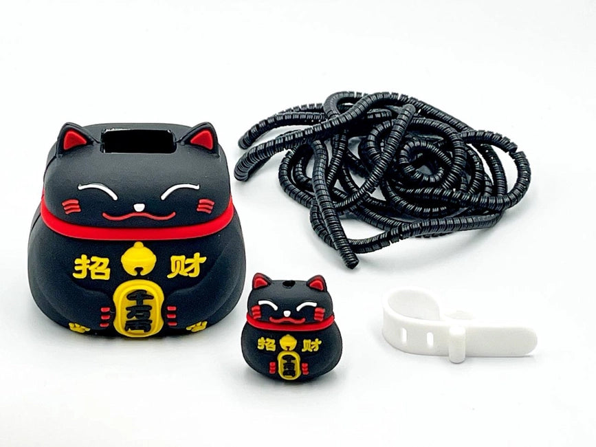 Black fortune cat charger cover and mini fortune cat cable protector with black spiral cable wrap on white surface