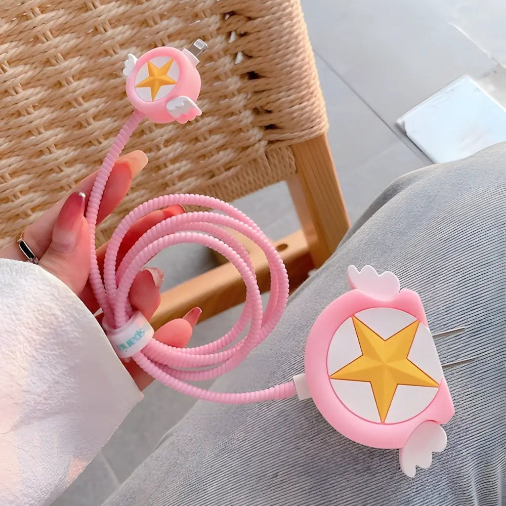Pink winged star charger cover and mini cable protector with pink spiral cable wrap on white ceramic plate with kraft paper background