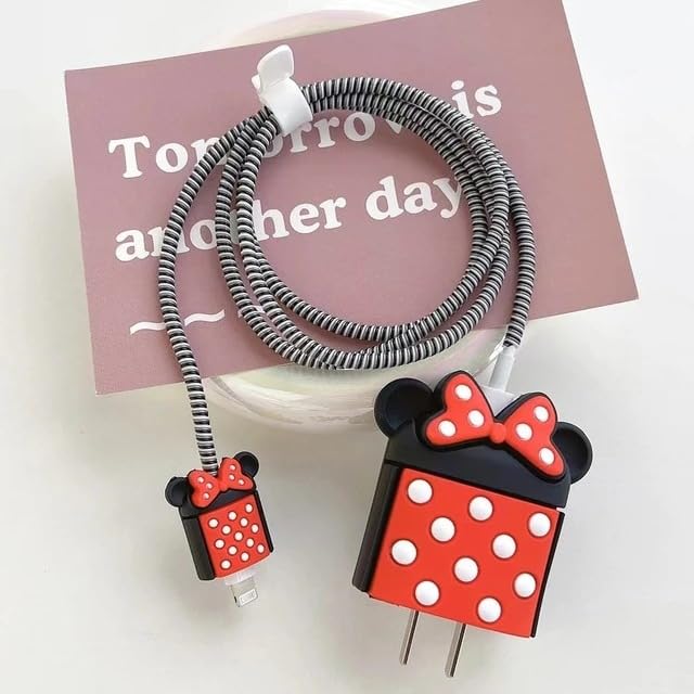 Bow mouse silicone iPhone charger adapter cover and cable protector set with black spiral winder on pink book lifestyle shot