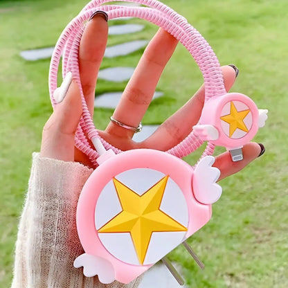 Pink winged star charger cover and mini cable protector with pink spiral cable wrap on white surface next to pink gift box