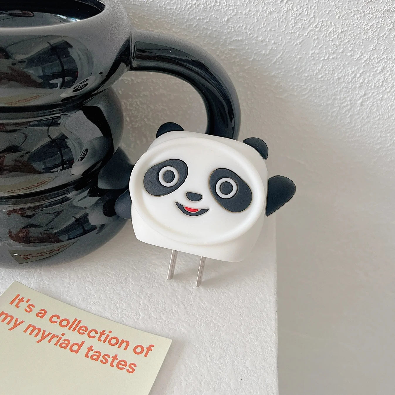 3D panda face iPhone charger cover full set with coiled white cable on white background
