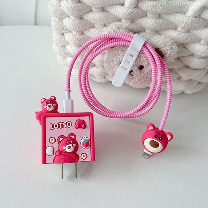Strawberry bear charger adapter cover on iPhone charger with pink coil cable winder - lifestyle shot