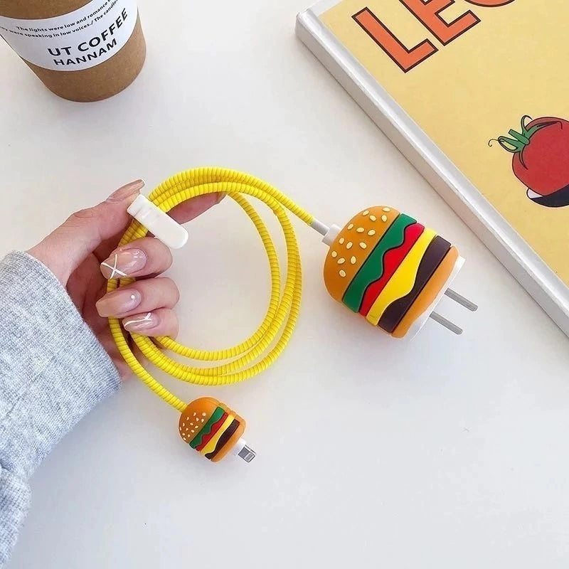 Burger silicone iPhone charger adapter cover and mini cable protector with yellow spiral cable winder held in hand