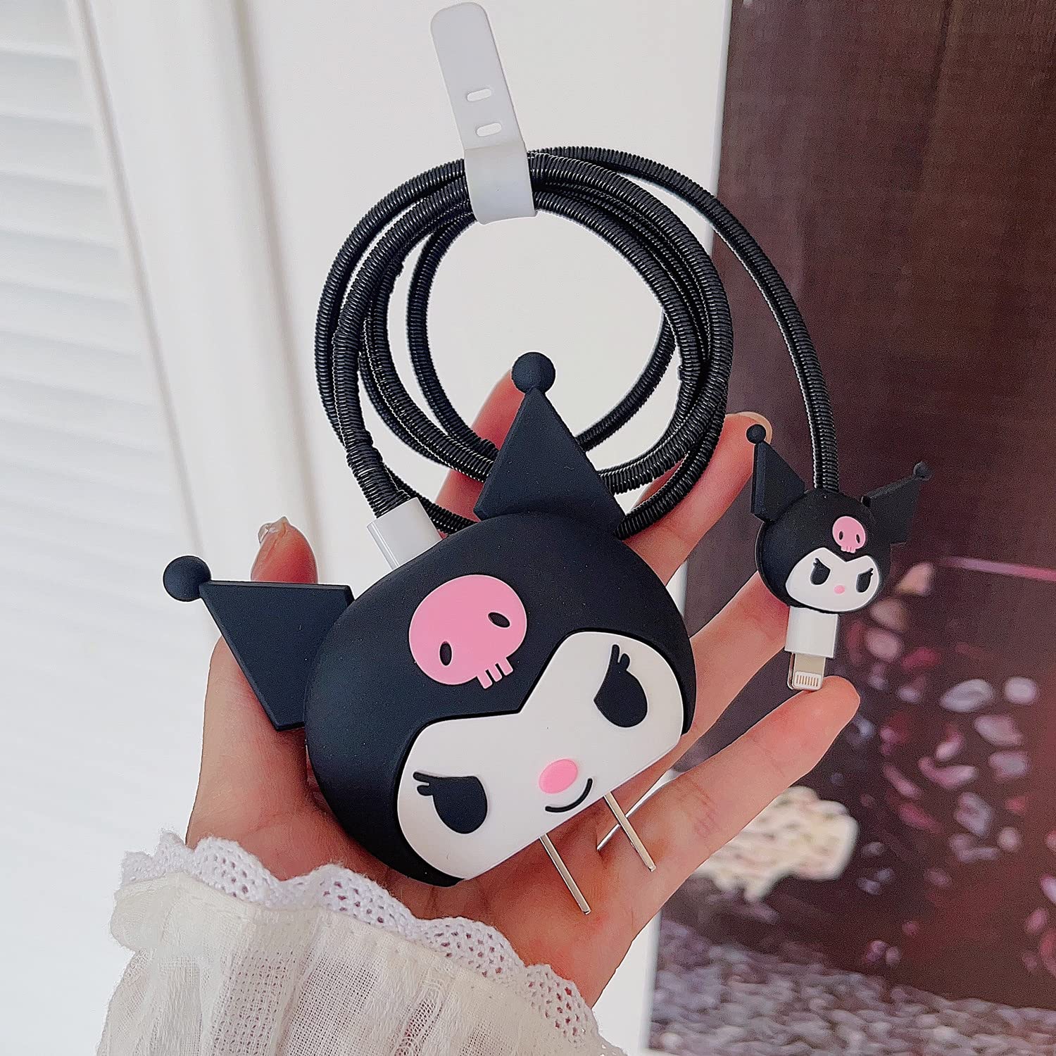 Kuromi charger adapter cover with cable protector on wooden surface