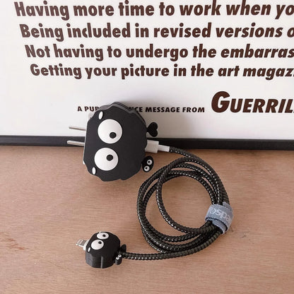 Black fluffy spirit charger cover and mini spirit cable protector with black spiral cable wrap held up against white wall