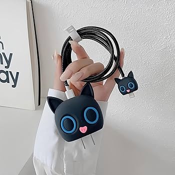 Black cat charger adapter cover and mini cable bite with black coil winder held in hand - white background