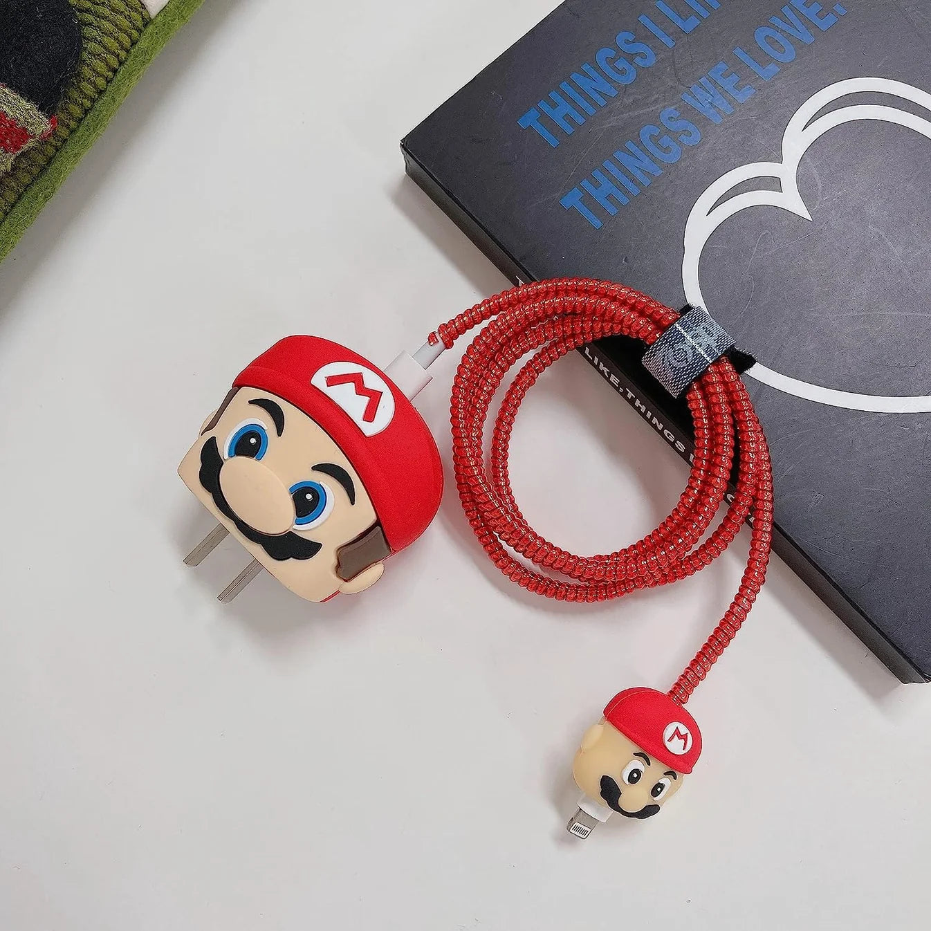 Yellow cartoon character charger cover and cable protector set on gift box with Christmas decor