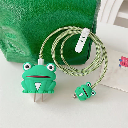 Green frog charger cover on adapter with green spiral cable wrap against green leather bag