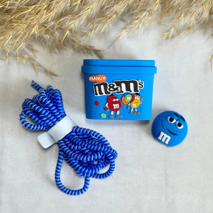 Blue candy box charger cover and mini round candy cable protector with blue spiral cable wrap on white fur surface with dried grass background
