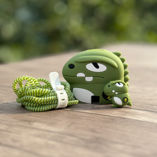 Dino monster charger adapter cover with green coil cable winder - lifestyle flat lay