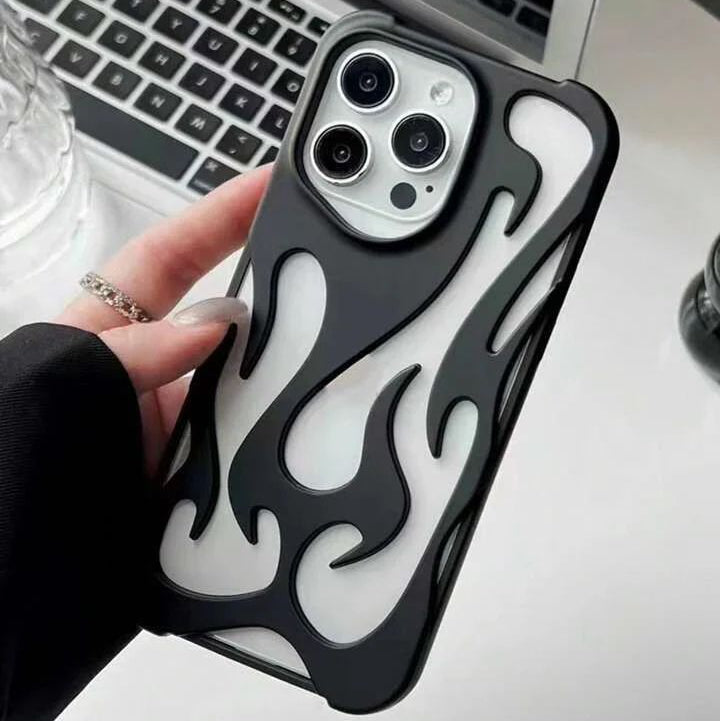 Black phone case with flame design held in front of a laptop