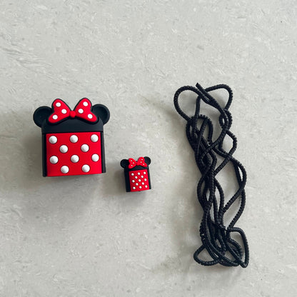Bow mouse charger adapter cover, mini cable protector and black spiral cable winder flat lay on white surface
