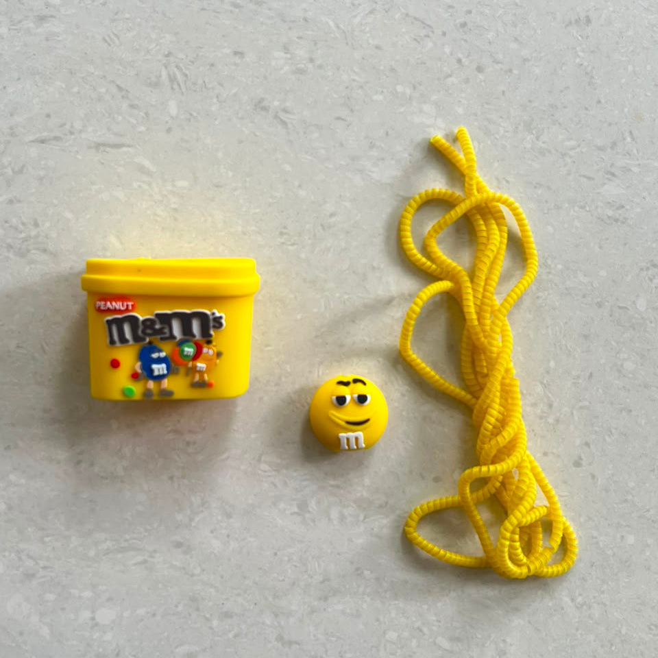 M&M's Peanut charger adapter cover and cable protector set with yellow coil winder - lifestyle shot