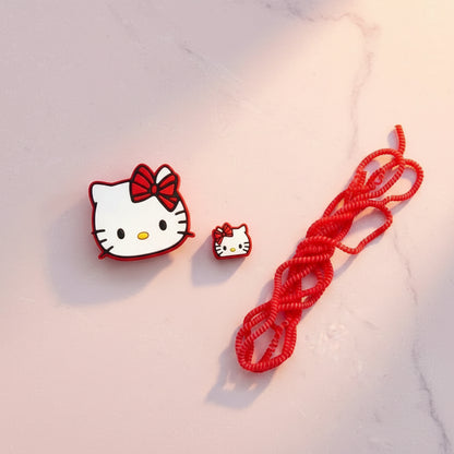 Bow kitty charger adapter cover with mini cat cable bite and red coil winder - flat lay on white background