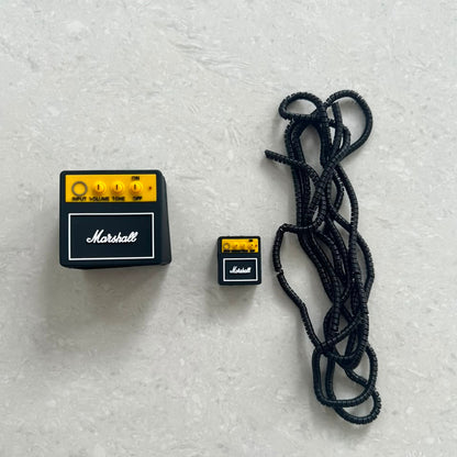 Rock amp charger adapter cover and mini amp cable bite with black coil winder - flat lay components