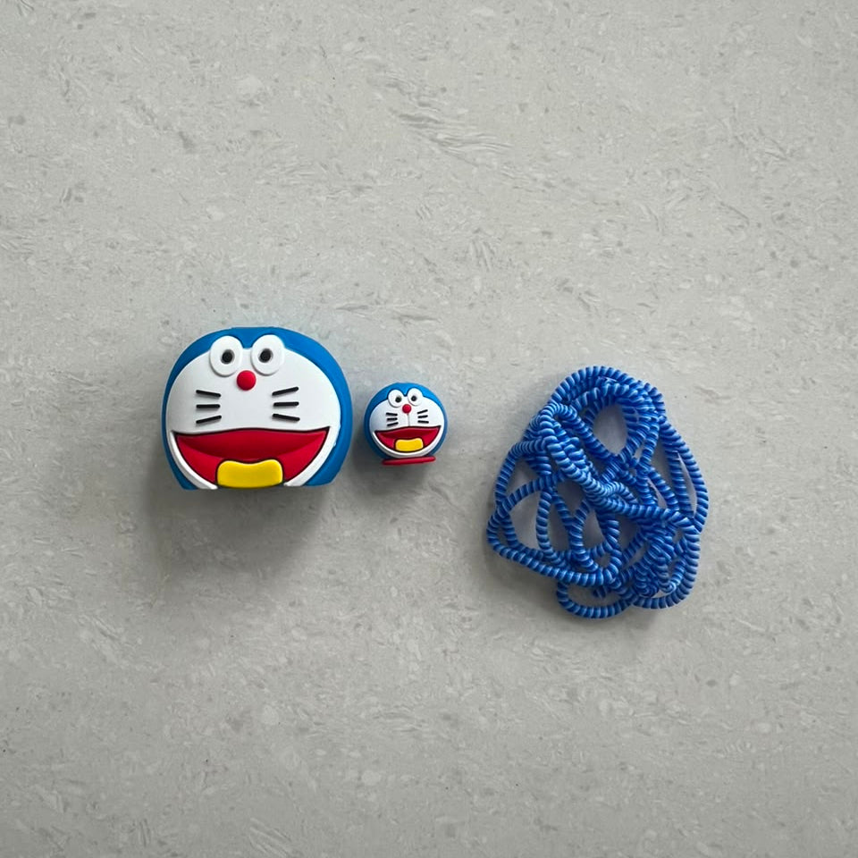 Blue kawaii cat face charger cover, cable protector and cable winder flat lay