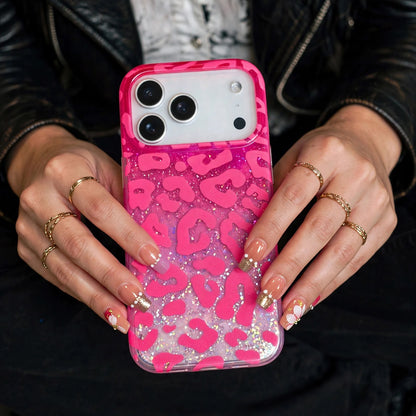 Hot pink leopard glitter iPhone case held by model with red nails