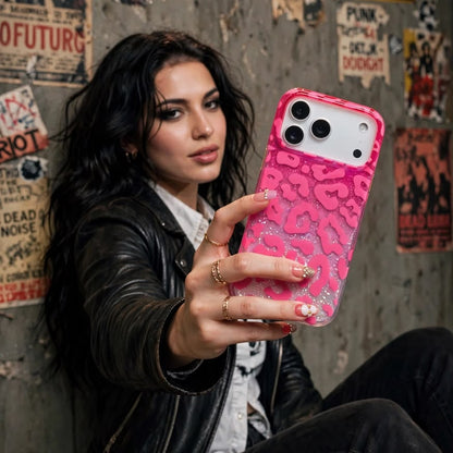 Side view of pink leopard glitter iPhone case on wooden surface