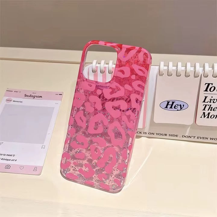 Model holding hot pink leopard glitter iPhone case with gold rings