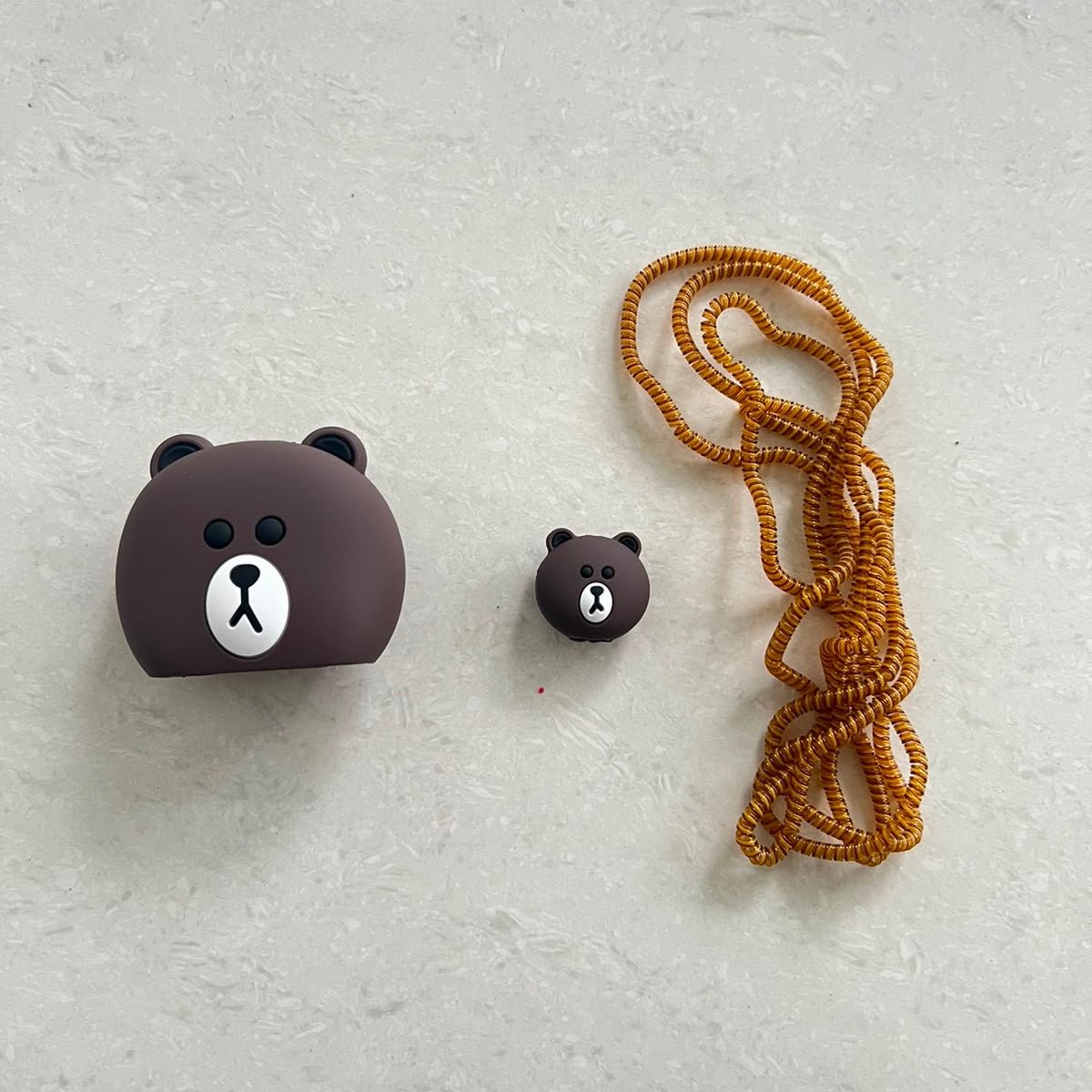 Brown Bear Charger Cover Mini Cable Bite and Brown Gold Coil Winder flat lay – iPouch