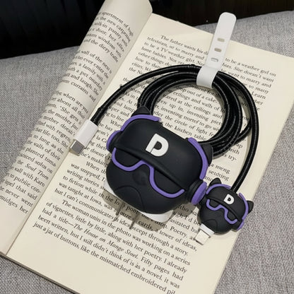 DJ Character iPhone charger adapter cover and cable protector on open book lifestyle shot