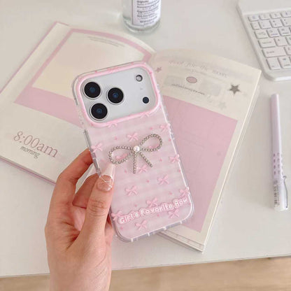 Girl's Favorite Bow pink iPhone case on desk - front view with rhinestone bow charm