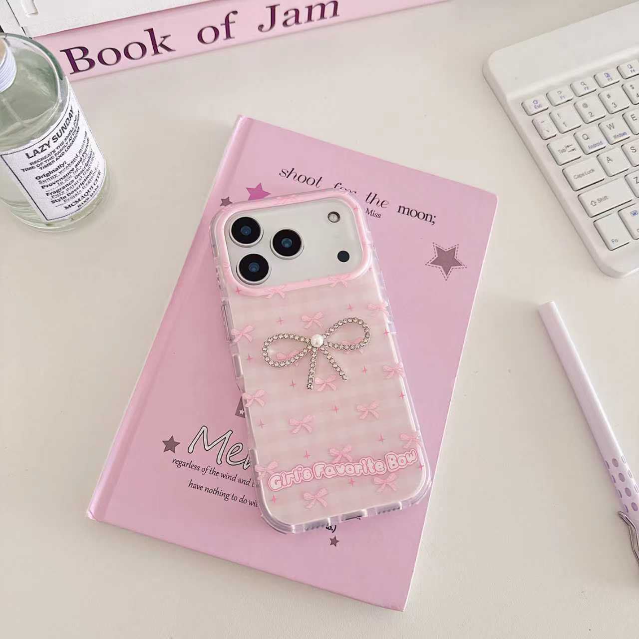 Girl's Favorite Bow pink iPhone case held in hand showing embossed bow pattern