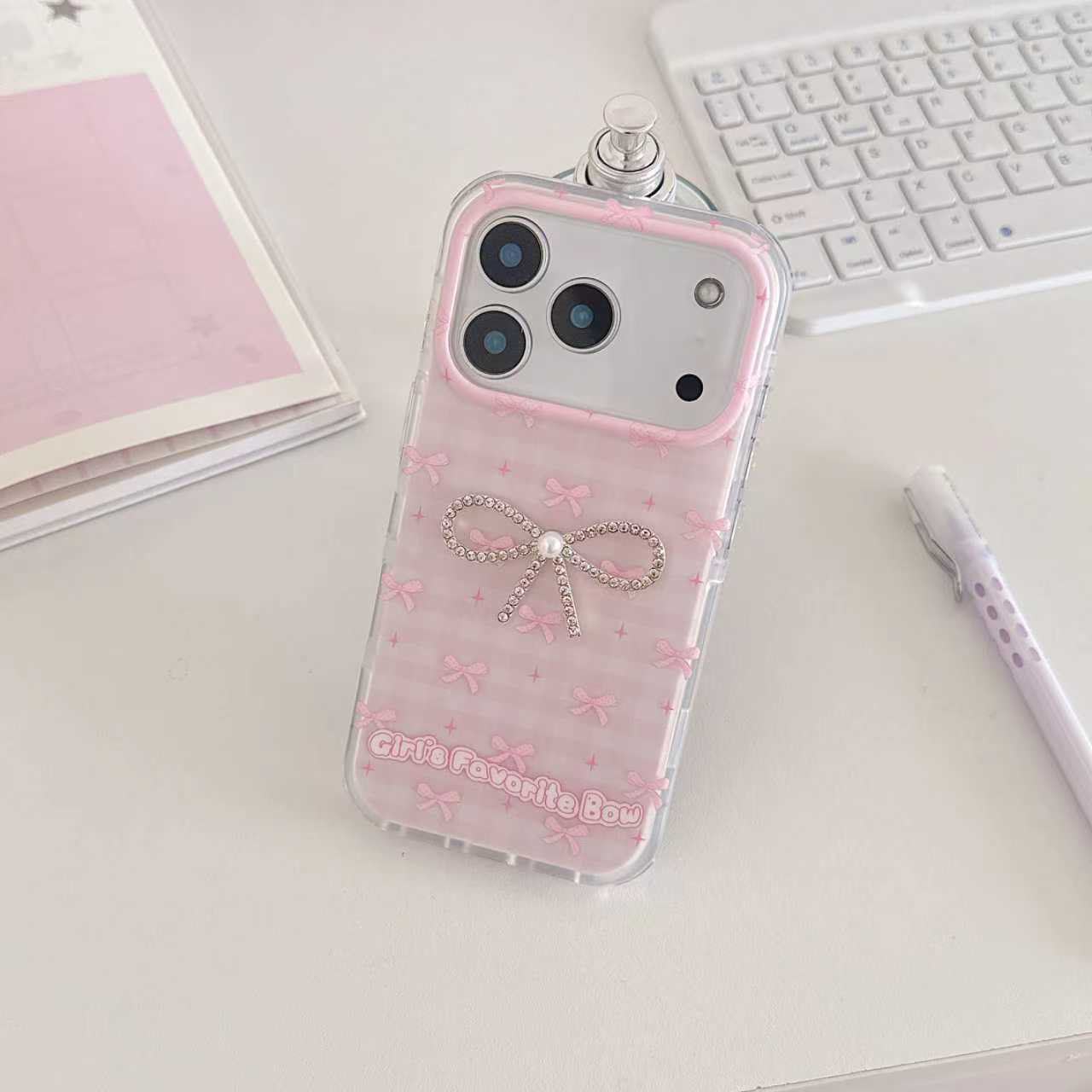 Girl's Favorite Bow pink iPhone case on pink journal lifestyle flat lay