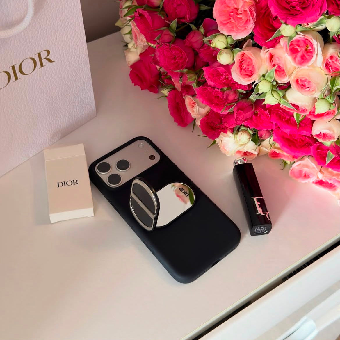 Luxury monogram phone grip open compact mirror on white table