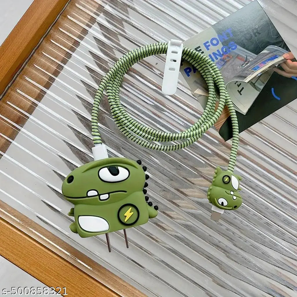 Dino monster charger cover and baby dino cable bite with green coil winder on wooden surface