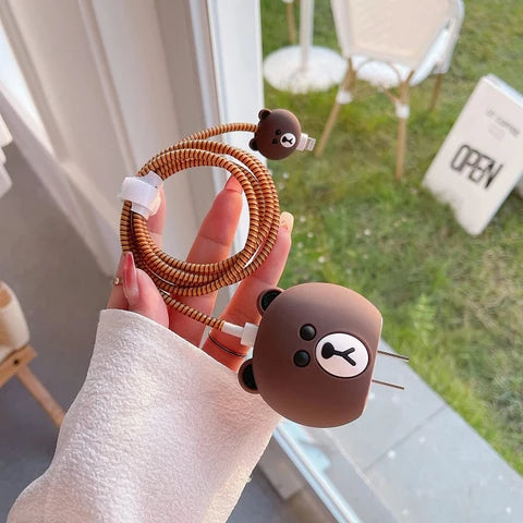 Brown Bear Charger Cover with Cable Bite and Brown Coil Winder held in hand – iPouch