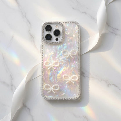 Woman holding iPouch Pearl Shell Bow iPhone Case with crystal bead wristlet at a café