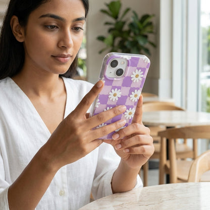 Woman holding Daisy Smiley Checkered iPhone Case purple at cafe lifestyle shot