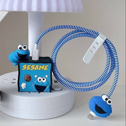 Blue and red fuzzy monster charger adapter covers with blue coil winder and mini monster cable bite - lifestyle shot on white lamp stand