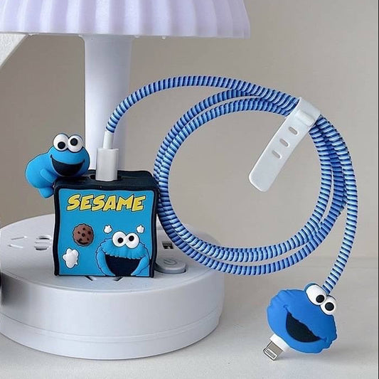Blue and red fuzzy monster charger adapter covers with blue coil winder and mini monster cable bite - lifestyle shot on white lamp stand